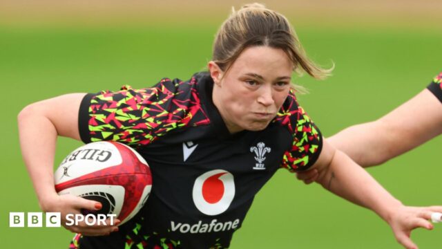 Alisha Joyce with ball under right arm runs forward in Wales training 