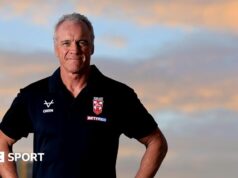 Brian McDermott to lead England into Rugby League World Cup Brian McDermott, wearing a black England polo shirt, looks to the camera, with the sky in the background